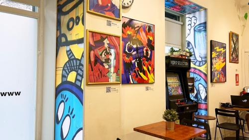 a room with colorful paintings on the wall at Way Hostel Madrid in Madrid