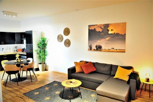 a living room with a couch and a table at The Oasis apartment, 2 bedrooms antwerp South in Antwerp