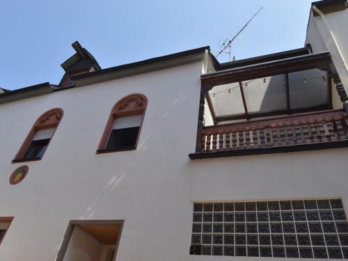 a white building with windows and a balcony at Attractive Apartment in Zell near River in Zell an der Mosel