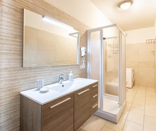 a bathroom with a sink and a shower at Appartamenti MOTIV Riccione in Riccione
