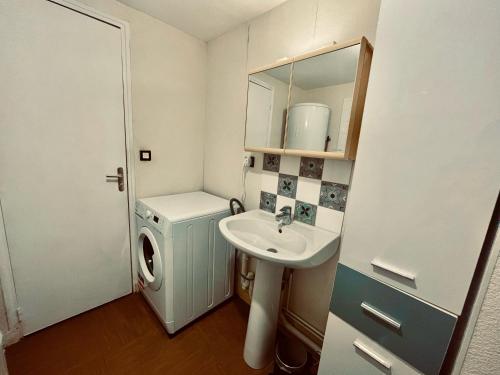 La petite salle de bains est pourvue d'un lavabo et d'un lave-linge. dans l'établissement F2 rue d'Illiers, à Orléans