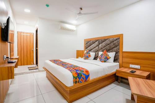 a bedroom with a large bed in a room at FabHotel Silver Inn in Ahmedabad