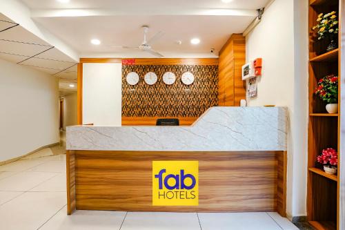 a fast food restaurant with a counter with a sign on it at FabHotel Silver Inn in Ahmedabad