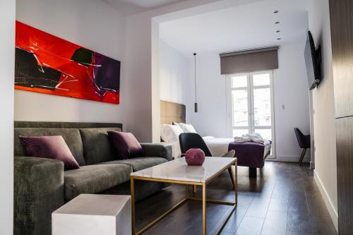 a living room with a couch and a table at ELITE APARTMENTS in Thessaloniki