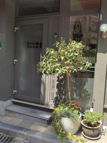 a front door of a house with a tree in front at PortaNova 21 in Huy