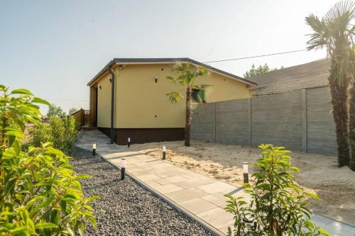 a backyard with a house and a fence at wellnessvrbice in Bohumín
