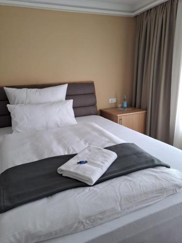 Ένα ή περισσότερα κρεβάτια σε δωμάτιο στο Hotel Rhin Inn