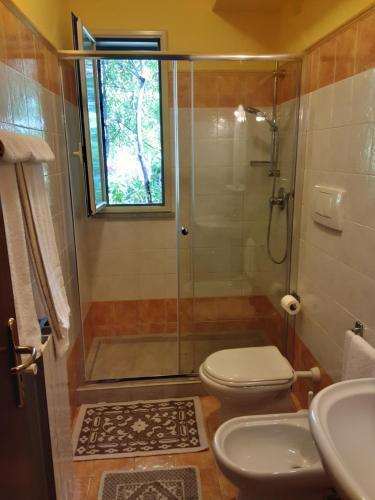 a bathroom with a shower and a toilet and a sink at B&B Villa Archegeta in Giardini Naxos