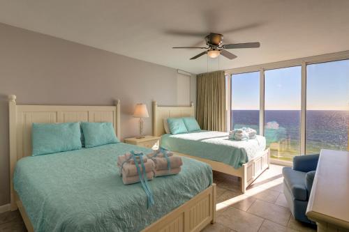a bedroom with two beds and a large window at Long Beach Resort 2-901 - Sunset Beach Club in Panama City Beach