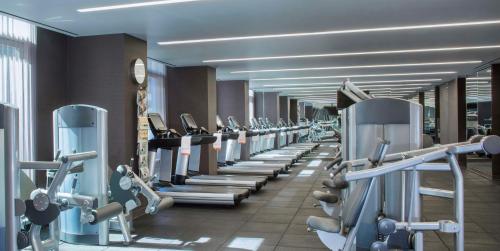 a gym with a row of treadmills and machines at Hyatt Centric Times Square New York in New York