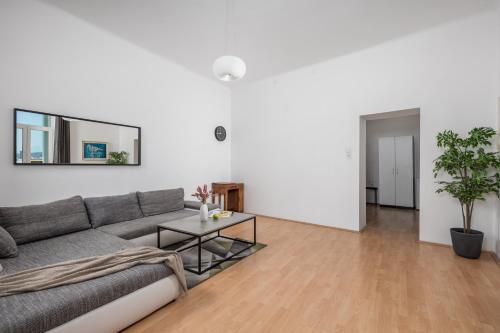 a living room with a couch and a table at Step to the Sea apartment in Rijeka