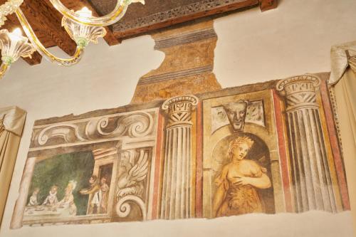 a painting on the wall of a room in a building at Villa Martin Hotel in Dolo