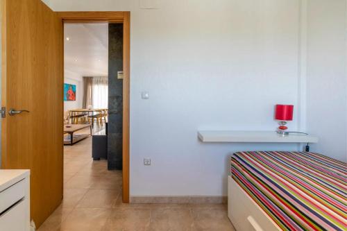 a bedroom with a bed with a red candle on it at luxury resort vistas al mar in Arenales del Sol