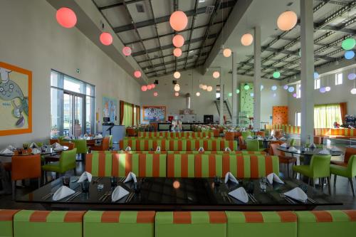 a dining room with tables and chairs and lights at Vila Gale Nep Kids in Beja