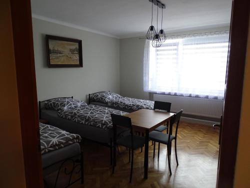 a living room with a couch and a table at Mieszkania pracowniczo-turystyczne in Żelazna