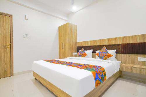 a bedroom with a large bed in a room at FabHotel Suraj Kunj in Indore