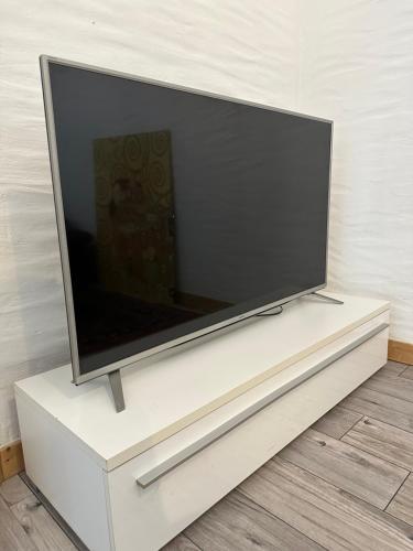 a flat screen tv sitting on a white entertainment center at Domizil in Schleiden