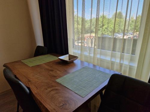 a wooden table with a view of a window at VIN service Dzelzcelnieku street 19 in Rēzekne