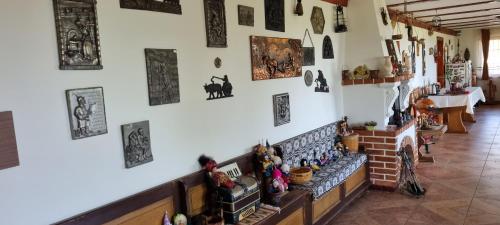 a room with a wall with many pictures on the wall at Pensiunea Printul Vlad in Sibiel
