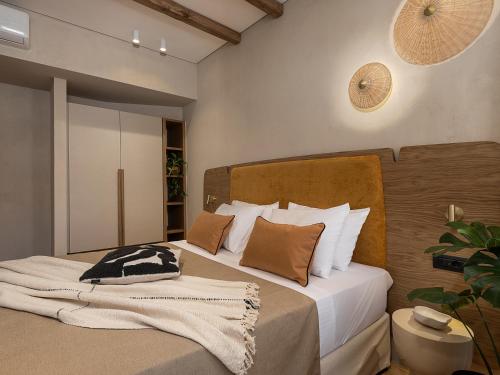 a bedroom with two beds with white and brown pillows at Casa Modiano Boutique in Chania