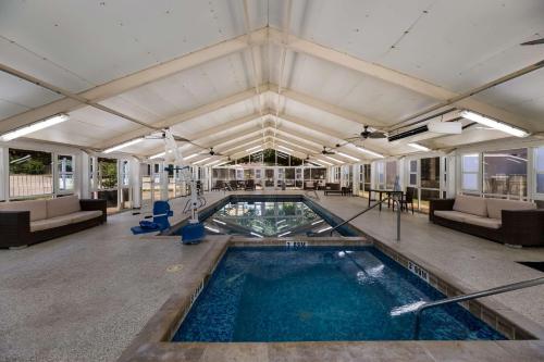 a swimming pool in a building with couches at Clarion Hotel San Angelo near Convention Center in San Angelo