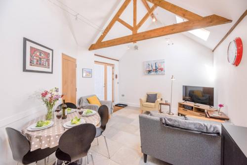 a living room with a table and chairs at Kipper Cottage, Southwold in Southwold