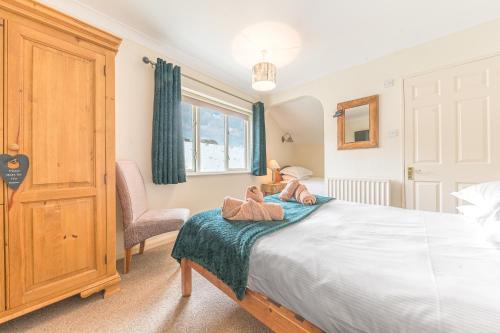 a bedroom with a bed with two teddy bears on it at Meadowdore Stay B&B in Coniston