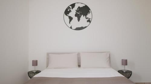 a bedroom with a white bed and a globe on the wall at Taormina 5 stars - Villa 5 minutes from the beach in Riposto