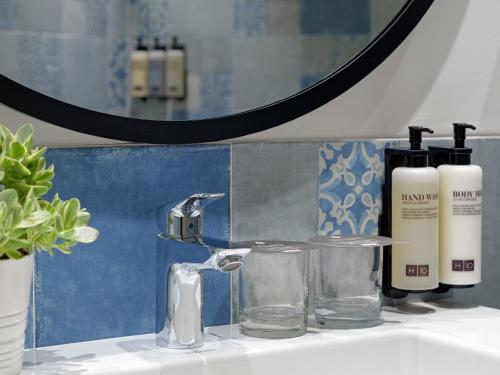 a bathroom counter with a sink and a mirror at H10 Casa del Mar in Santa Ponsa