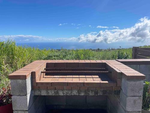 a brick patio with a view of the ocean at La Clé des Hauts in Maison Lelièvre