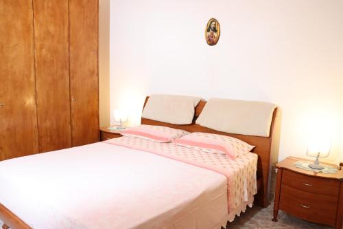 a bedroom with a bed with two pillows on it at Casa Vacanze Galatone delle Arance in Galatone
