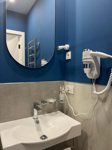 a bathroom with a white sink and a mirror at Sweet Home Apart-Hotel in Yerevan