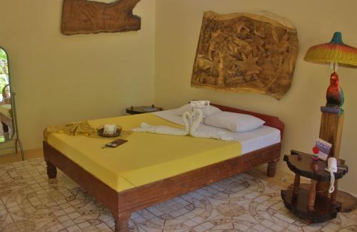 a bedroom with a bed with towels on it at Deep Forest Garden Hotel in Puerto Princesa City