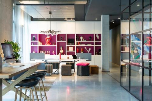 a dining room with a table and purple walls at Moxy Frankfurt Airport in Frankfurt/Main