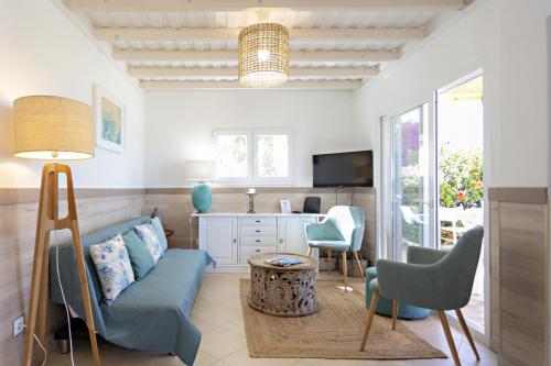 a living room with a couch and chairs and a table at Villa Lydia in Faro