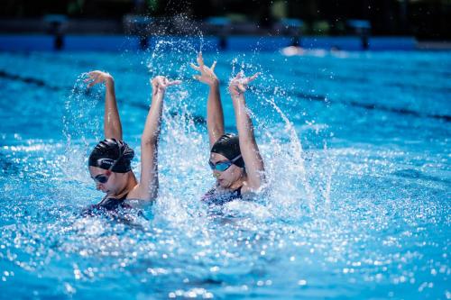 two people in the water in a swimming pool at Hills Resort Hotel in Yerevan