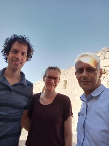 two men and a woman standing next to each other at شقة سيلا in Irbid