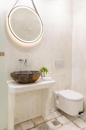 a bathroom with a sink and a mirror on the wall at Katerina Roza Studios - Heartfelt Hospitality in the City in Naxos Chora