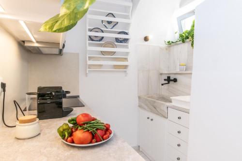 a bowl of fruit on a counter in a kitchen at PG Houses in Kalloni Village - PHouse in Kalloni Tinou