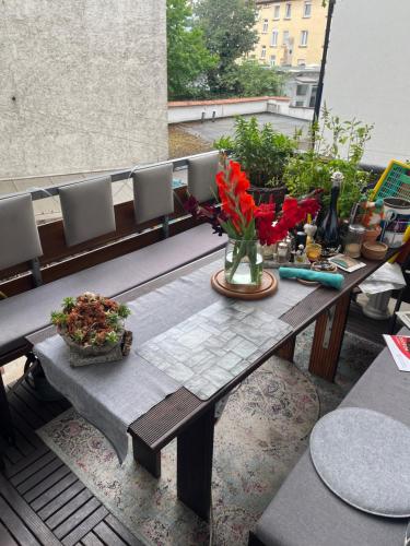 a table and chairs on a balcony with flowers on it at Mediterranean Room - Private Room in Mannheim