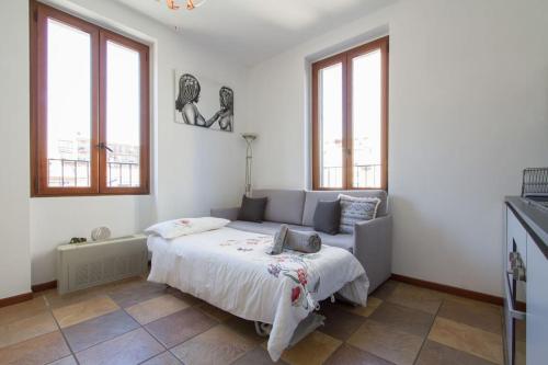 una camera con un letto in una stanza con finestre di Fabulous studio in Monza 15 km to Milan city centre a Monza
