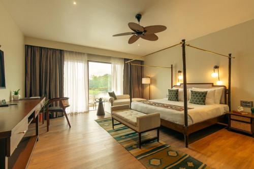 a bedroom with a bed and a ceiling fan at Oleander Farms, Karjat in Karjat
