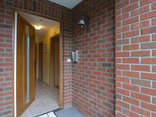 a brick wall with a door and a brick hallway at Luxury gite with sauna in Baugnez Malmedy in Arimont