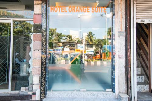 a glass door to a hotel orange sunrise sign at FabExpress Orange Suites - Nr Mumbai International Airport in Mumbai