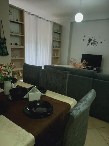 a living room with a table and a couch at Panoramic apartment in Shkodër