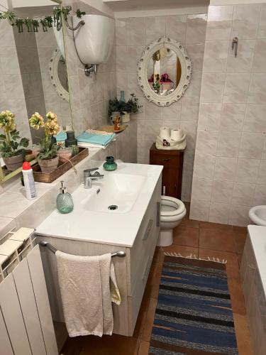 a bathroom with a sink and a toilet and a mirror at La Locanda delle Idee Perugia in Perugia