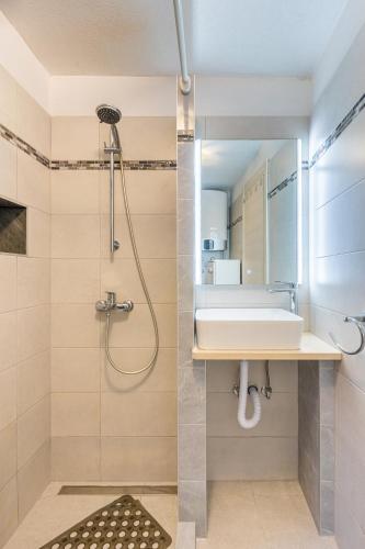 a bathroom with a sink and a shower at Apartman Robert Cres in Cres
