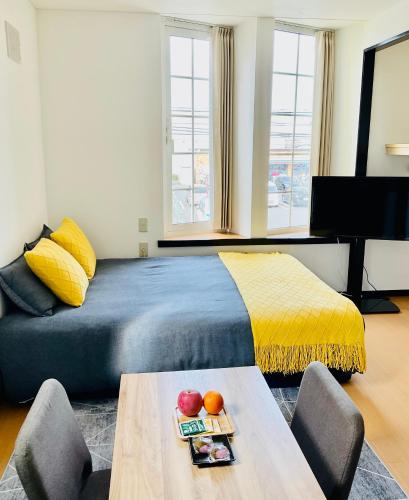 a bedroom with a bed and a table with fruit on it at Warm House4 in Sapporo