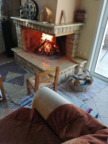 a fire place in a living room with a fireplace at AMAZING VIEW IN ANTHIDONA in Loukísia