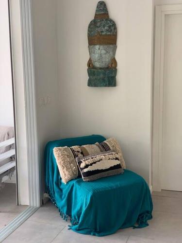 a chair with pillows on it in a room at Villa à 100 m à pied de la plage in Sainte-Anne